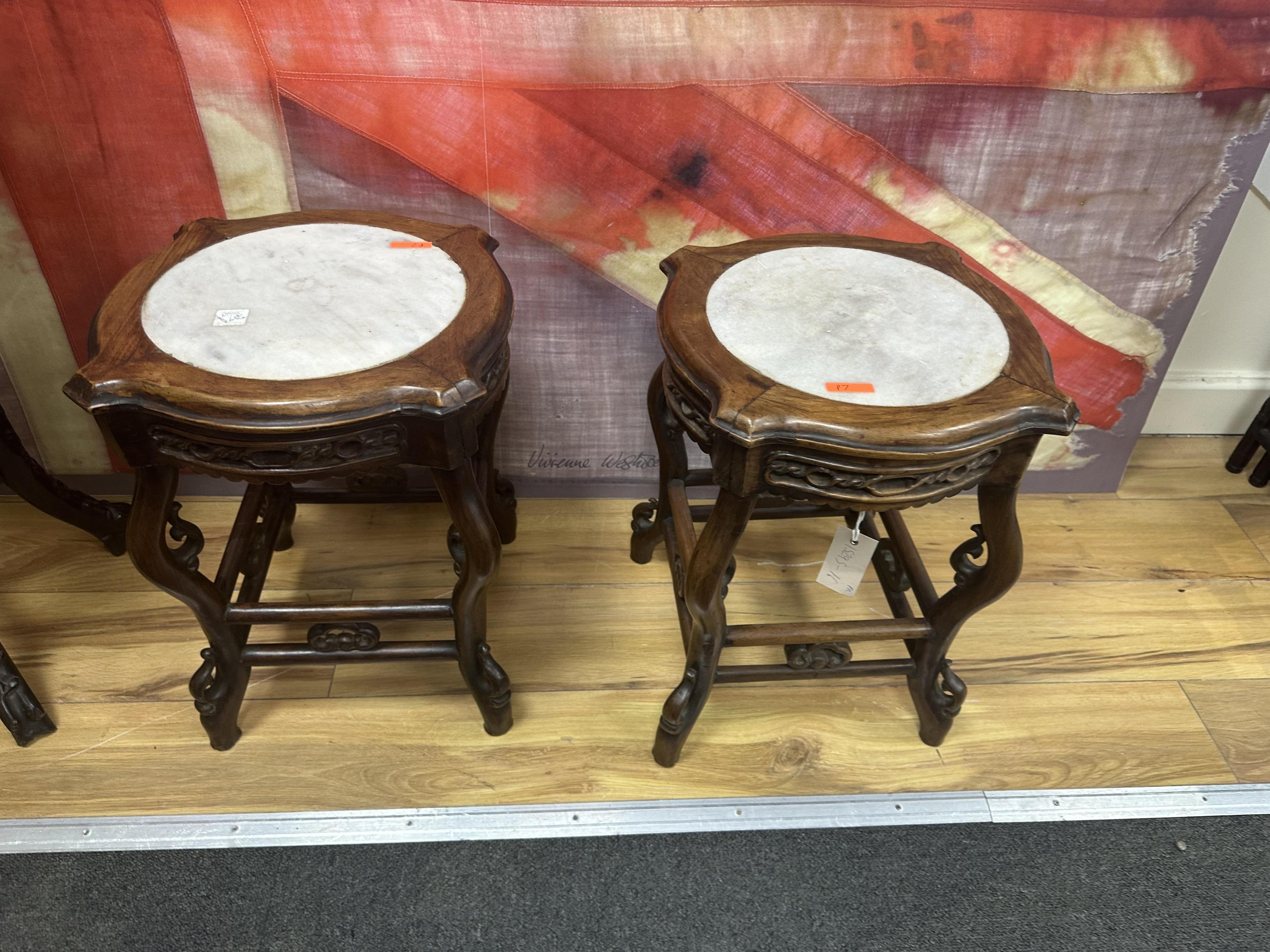 A pair of Chinese vase stands with white marble tops, width 35cm, height 45cm. Condition - fair to good